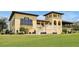 Stunning multi-story building with large windows, elegant staircases, and beautifully landscaped lawn at 7616 Cabana Ct # 301, Reunion, FL 34747