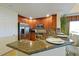 Eat-in kitchen with stainless steel appliances, wood cabinets, and granite countertops at 7616 Cabana Ct # 301, Reunion, FL 34747