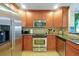 Well-equipped kitchen with stainless steel appliances, wood cabinets, and granite countertops at 7616 Cabana Ct # 301, Reunion, FL 34747