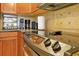 Close-up of kitchen appliances, including oven, stovetop, and granite countertops at 7616 Cabana Ct # 301, Reunion, FL 34747