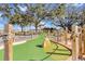 Charming mini golf course featuring green turf, wood, rock and rope accents, perfect for Gathering fun at 7616 Cabana Ct # 301, Reunion, FL 34747