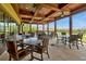 Inviting outdoor patio with wood ceilings, fans, dining tables and chairs, offering picturesque views at 7616 Cabana Ct # 301, Reunion, FL 34747