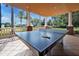 Outdoor ping pong table under a covered patio area, perfect for recreational activities at 7616 Cabana Ct # 301, Reunion, FL 34747