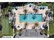 Aerial view of sparkling pool with palm trees, lounge chairs, and umbrellas for a resort-style experience at 7616 Cabana Ct # 301, Reunion, FL 34747