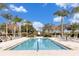 Relaxing community pool surrounded by palm trees and lounge chairs, perfect for leisure at 7616 Cabana Ct # 301, Reunion, FL 34747