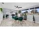 Spacious dining area with large windows, marble floors, and modern furnishings at 8120 Gondola Dr, Orlando, FL 32809