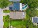 This aerial view showcases the home, the pool, and lush landscaping with a manicured lawn at 830 Oak St, Orlando, FL 32804