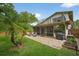 Large backyard featuring a patio, screened-in porch, balcony and manicured lawn at 830 Oak St, Orlando, FL 32804