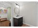 Modern bathroom features a circular mirror over dark vanity with custom tile work at 830 Oak St, Orlando, FL 32804