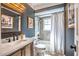 Contemporary bathroom with dark blue walls, framed art, and shower-tub combo at 830 Oak St, Orlando, FL 32804