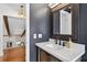 Stylish bathroom with a modern vanity, decorative mirror, and warm lighting at 830 Oak St, Orlando, FL 32804