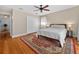Cozy bedroom features hardwood floors, a ceiling fan, and a spacious closet at 830 Oak St, Orlando, FL 32804
