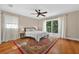 Bright bedroom with hardwood floors, ceiling fan, and sliding door to a balcony at 830 Oak St, Orlando, FL 32804