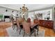 Elegant dining room showcasing a chandelier and wood table and chairs, adjoined by open-concept living area at 830 Oak St, Orlando, FL 32804