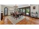 This dining room features a modern chandelier, a large table, and backyard access at 830 Oak St, Orlando, FL 32804