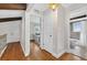 Hallway leading to a full bathroom with hardwood floors and white doors at 830 Oak St, Orlando, FL 32804