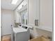 Laundry room equipped with new appliances, ample storage cabinets, and a utility sink at 830 Oak St, Orlando, FL 32804