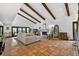 Bright living room boasts terracotta tile flooring, exposed wood beams, and a cozy fireplace at 830 Oak St, Orlando, FL 32804