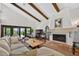 Bright living room featuring a fireplace, terracotta tile floors and vaulted ceilings at 830 Oak St, Orlando, FL 32804