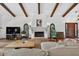 Living room showcasing terracotta tile flooring, fireplace, and vaulted ceilings with wood beams at 830 Oak St, Orlando, FL 32804