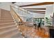 Open-concept floor plan featuring a staircase, terracotta tile floors and natural light at 830 Oak St, Orlando, FL 32804