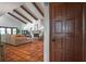 Bright living room features an open floorplan, exposed beams, and red tile floors at 830 Oak St, Orlando, FL 32804
