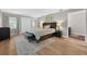 Bedroom featuring a king-size bed, light-colored walls, hardwood flooring, and closet storage at 830 Oak St, Orlando, FL 32804