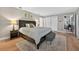 Bedroom featuring a king-size bed, light-colored walls, hardwood flooring, and closet storage at 830 Oak St, Orlando, FL 32804