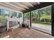 A screened lanai features a modern fireplace, tile flooring, and access to the outdoor patio at 830 Oak St, Orlando, FL 32804