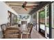 A screened lanai features an entertainment space with tile flooring and a wood table at 830 Oak St, Orlando, FL 32804