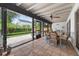 Spacious, screened lanai with tile floors, access to the fenced backyard, and outdoor seating at 830 Oak St, Orlando, FL 32804