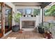Covered screened in porch with a fireplace and tiled floor at 830 Oak St, Orlando, FL 32804