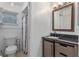 Bathroom featuring a modern vanity, granite countertop, mirror, and shower at 856 Mendoza Dr, Kissimmee, FL 34758