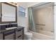 Well-lit bathroom features a modern vanity, framed mirror, and a shower-tub combination with curtain at 856 Mendoza Dr, Kissimmee, FL 34758