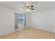 Cozy bedroom with a ceiling fan, tile flooring, and natural light from a window at 856 Mendoza Dr, Kissimmee, FL 34758