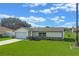 Exterior of the home with fresh lawn, featuring an attached two-car garage at 856 Mendoza Dr, Kissimmee, FL 34758