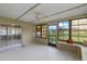 Bright Florida room featuring white tile flooring, bench seating, and several windows at 856 Mendoza Dr, Kissimmee, FL 34758