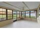 Enclosed Florida room with large windows and a ceiling fan providing panoramic outdoor views at 856 Mendoza Dr, Kissimmee, FL 34758
