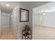 Inviting hallway with tiled floors, a decorative mirror, and views into the spacious living area at 856 Mendoza Dr, Kissimmee, FL 34758