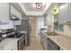 Bright kitchen with stainless appliances, sleek gray cabinetry, and plenty of counter space at 856 Mendoza Dr, Kissimmee, FL 34758