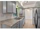 Kitchen featuring ample counter space, stainless steel appliances, and modern gray cabinetry at 856 Mendoza Dr, Kissimmee, FL 34758
