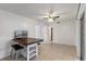 Living room featuring tiled floors, a kitchen bar with seating, and access to a sunroom at 856 Mendoza Dr, Kissimmee, FL 34758
