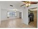 Open-concept living room with tiled floors and plenty of natural light at 856 Mendoza Dr, Kissimmee, FL 34758