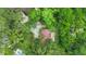 Aerial shot features home amidst lush trees and landscaping, complete with a horseshoe driveway at 874 Quarters Ct, Port Orange, FL 32129