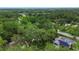 Aerial image shows the house with mature trees, pool, and solar panels at 874 Quarters Ct, Port Orange, FL 32129
