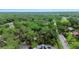 Expansive overhead view highlighting a property next to a park, and lush mature landscaping at 874 Quarters Ct, Port Orange, FL 32129