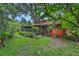 View of the back of the home and the screen enclosed porch from the backyard at 874 Quarters Ct, Port Orange, FL 32129
