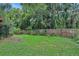 Spacious backyard with a wooden fence and mature trees creating a private oasis at 874 Quarters Ct, Port Orange, FL 32129