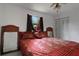 This bedroom features a stylishly decorated bed, a ceiling fan, and natural light from the window at 874 Quarters Ct, Port Orange, FL 32129