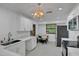 Bright kitchen with white cabinets, countertops and dining area, offering a modern and clean space at 874 Quarters Ct, Port Orange, FL 32129